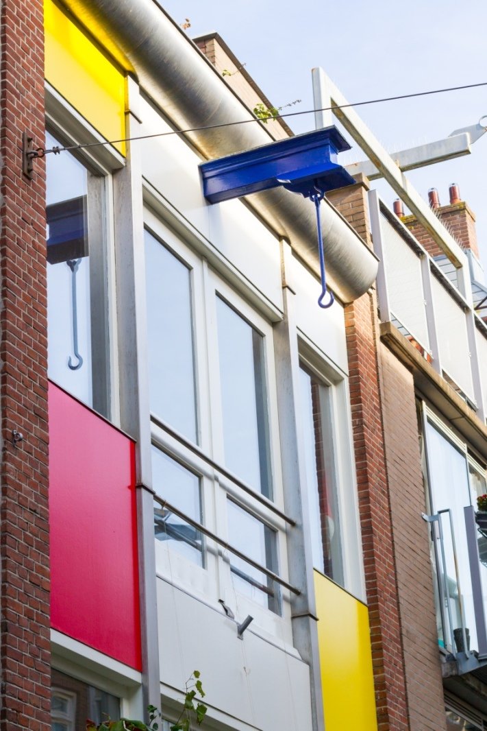 Colourful houses with beams to move things since the building are too think to have practical stairway access