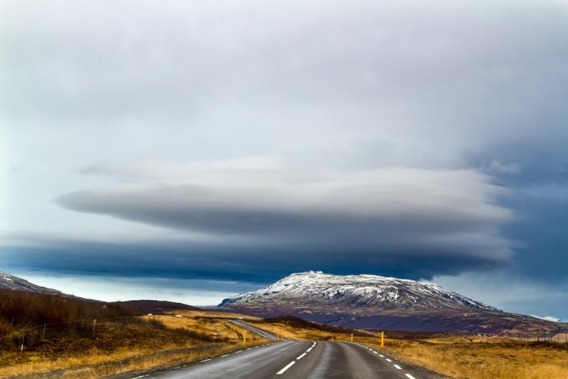 Cloud sitting atop a mountain