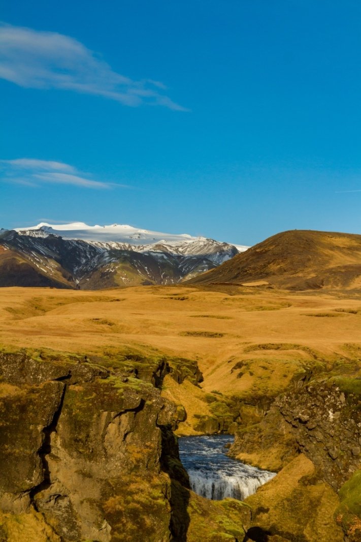 Walking along the Skógá River up from Skógafoss. A lovely warm day with the sounds of water intermittent as the river ducked deep into the earth and back out again and with the mist shooting up in the distance to signal the location of the next waterfall